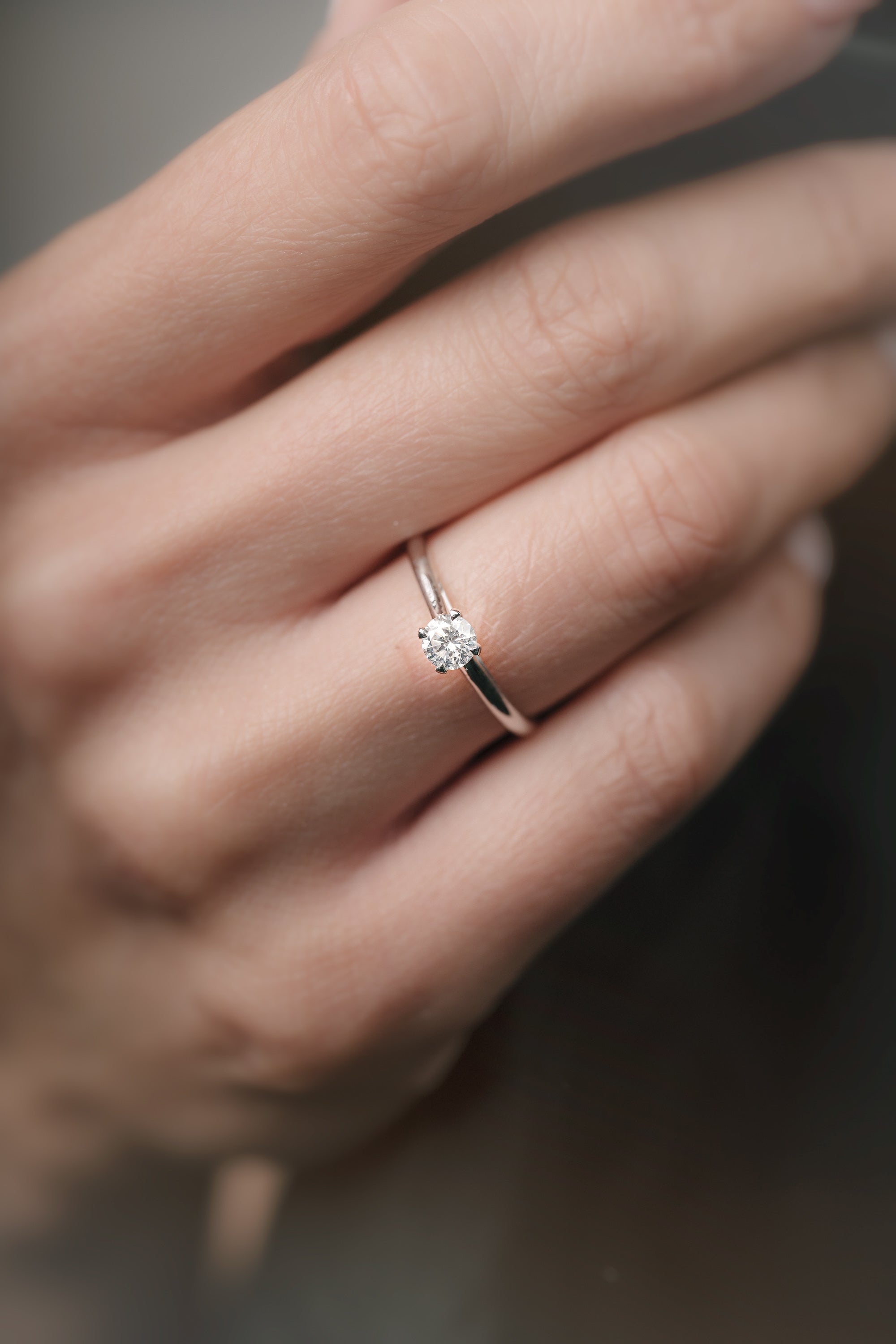 A simple brilliant-cut engagement ring on hand. 