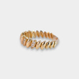 Gold ring with small zircons on a light gray background