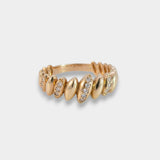 Gold ring with embedded stones on a light gray background