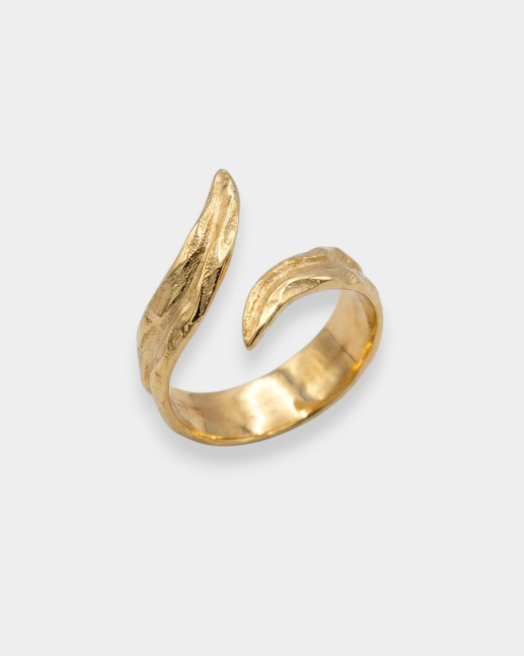 Gold ring with a unique design on a white background