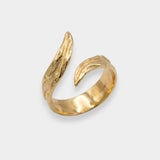Gold ring with a unique design on a white background