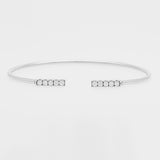White gold bangle with small zircons on a light gray background