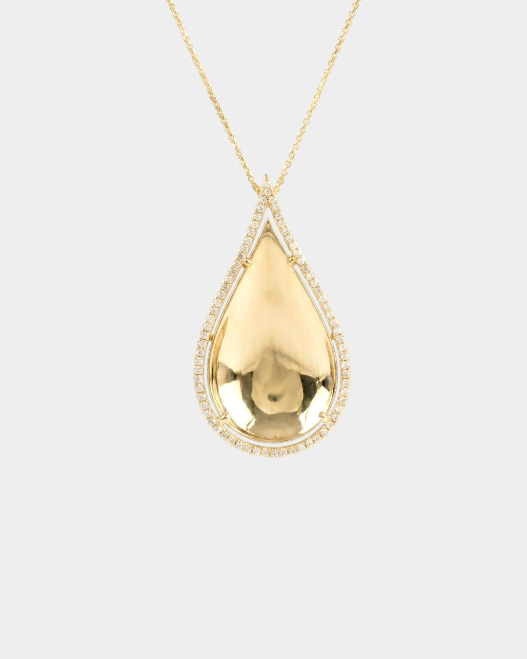 Gold teardrop pendant necklace on a light gray background