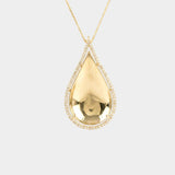 Gold teardrop pendant necklace on a light gray background