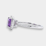 Ring with a purple amethyst and diamond accents on a white background side view