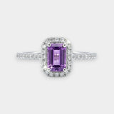 Ring with a purple amethyst and diamond accents on a white background