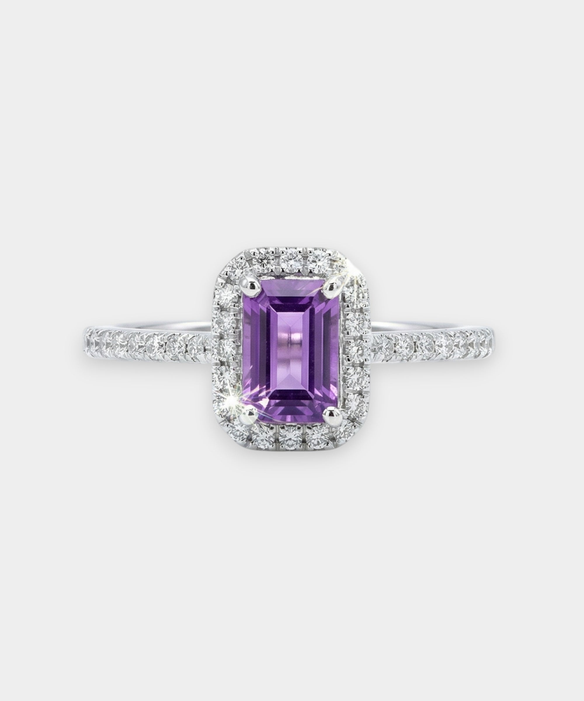 Ring with a purple amethyst and diamond accents on a white background