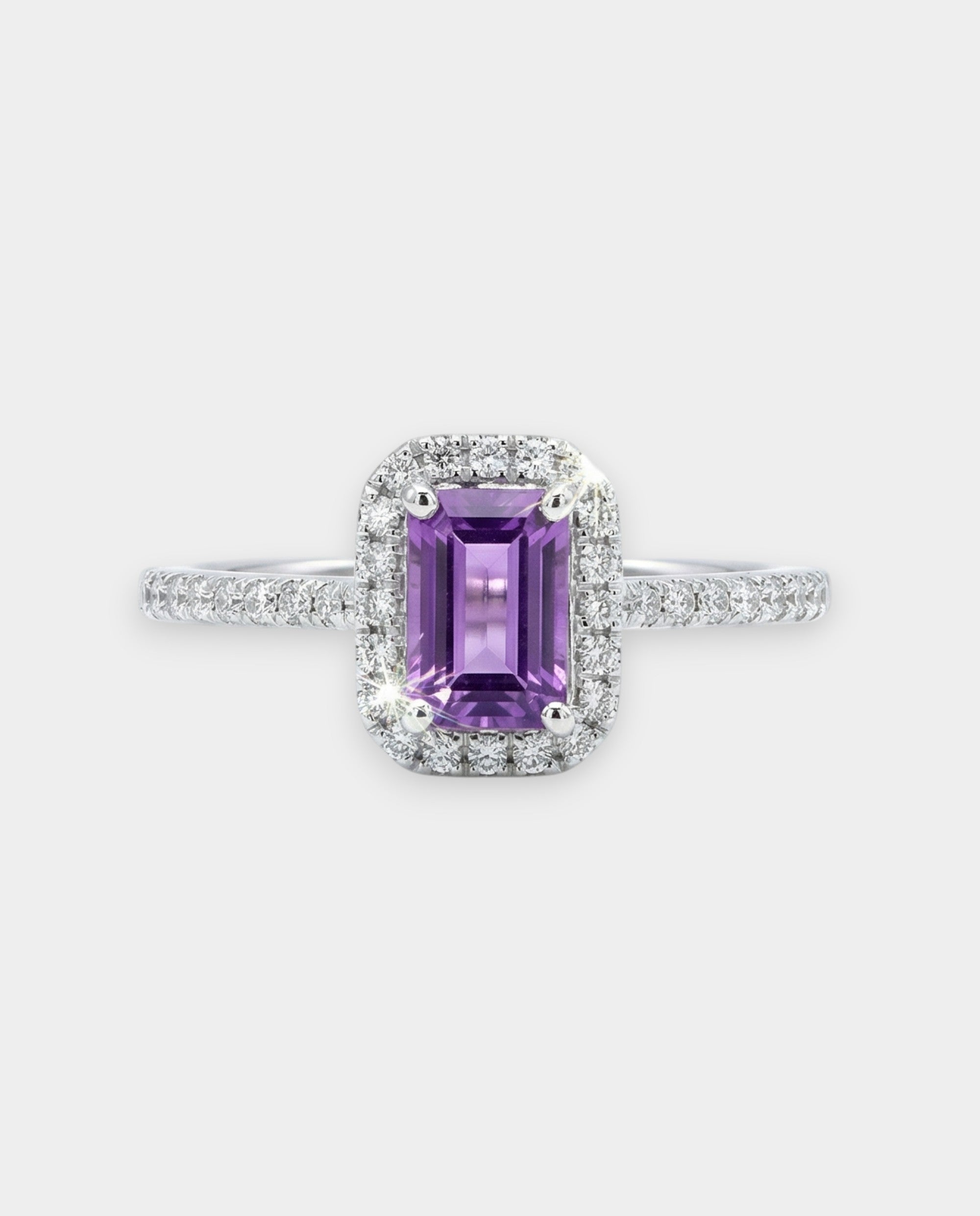Ring with a purple amethyst and diamond accents on a white background