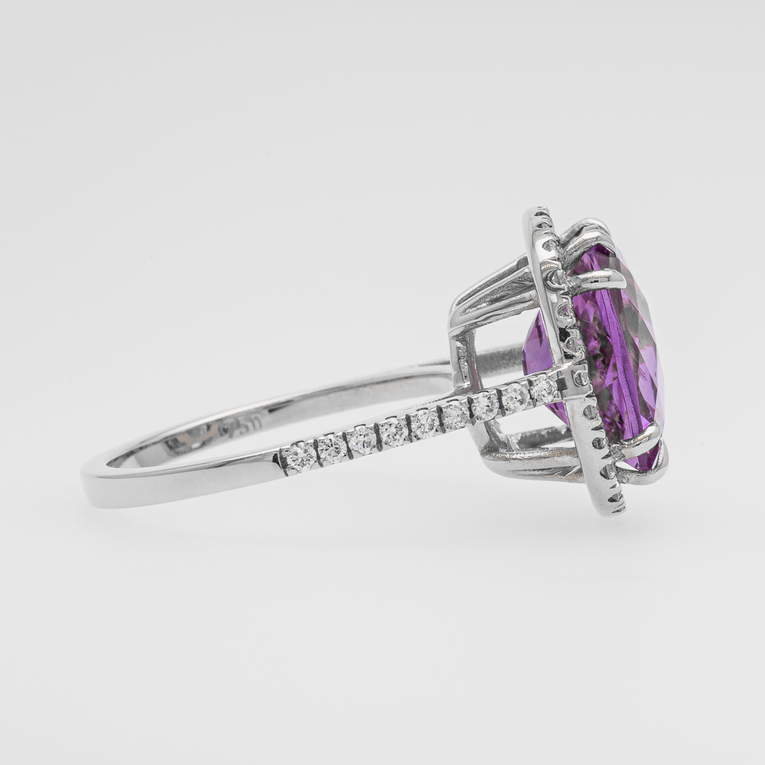 White good ring with a purple amethyst on a white background