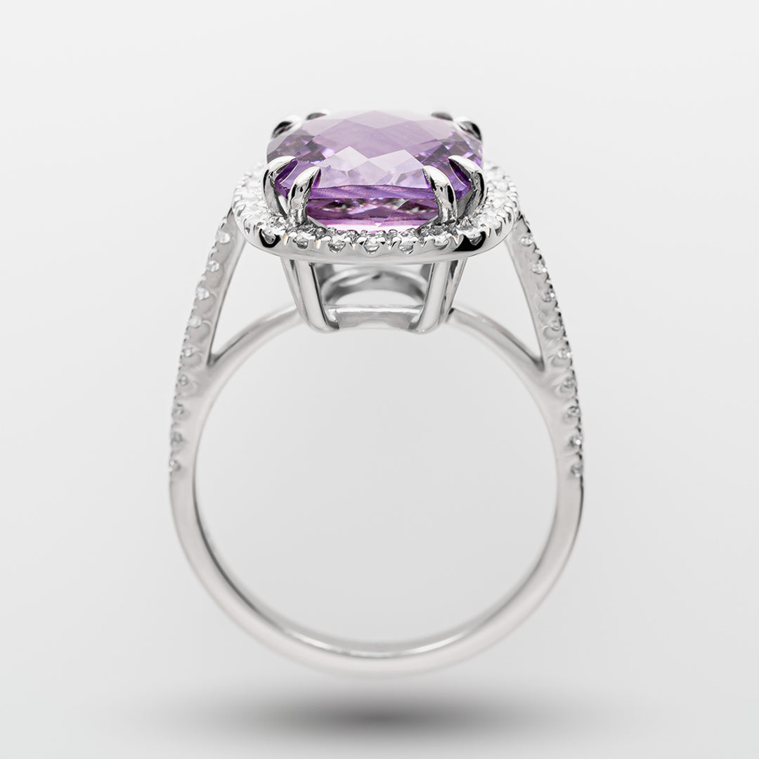 White gold ring with a purple amethyst on a white background
