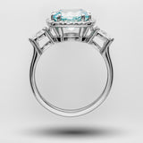White gold ring with a blue aquamarine gemstone on a light gray background
