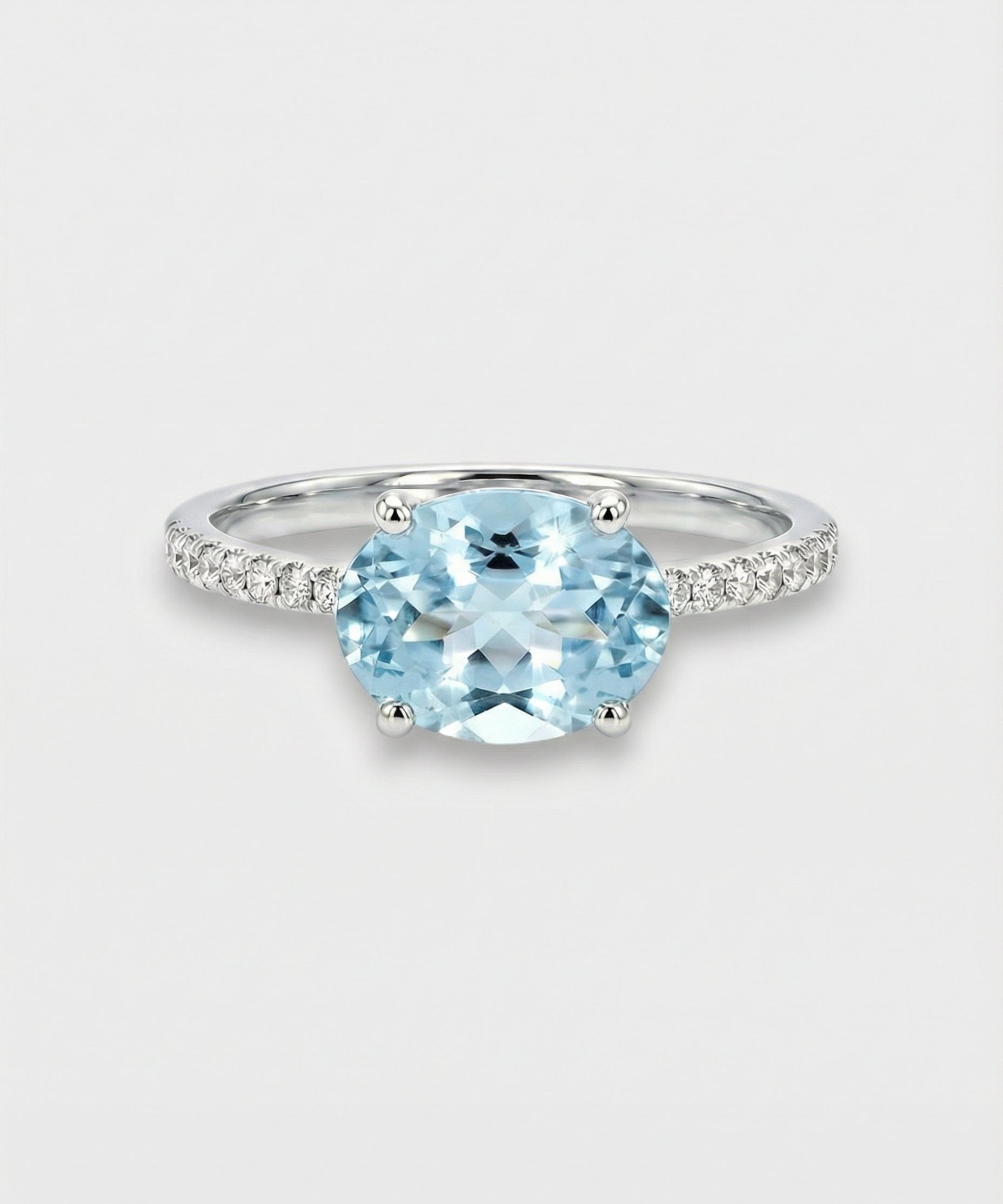 Ring with a oval-cut blue aquamarine on a light gray background
