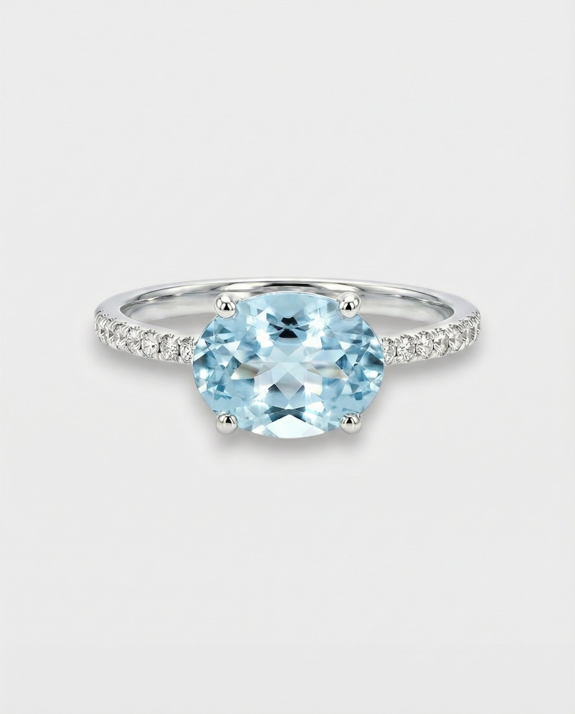 Ring with a oval-cut blue aquamarine on a light gray background
