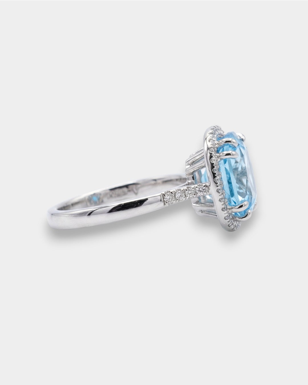 White gold ring with a blue topaz on a white background