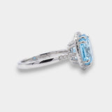 White gold ring with a blue topaz on a white background