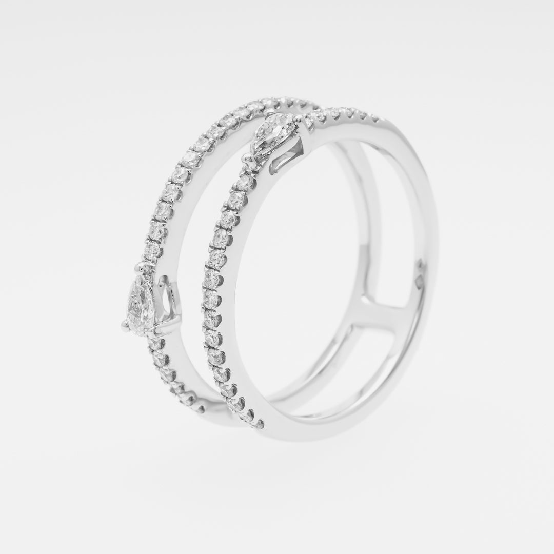 Silver ring with embedded stones on a light gray background