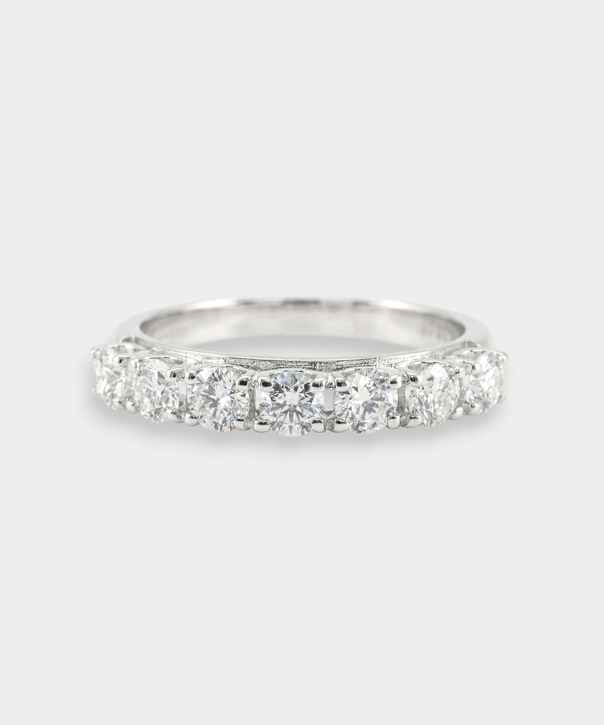 White gold ring with diamonds on a light gray background
