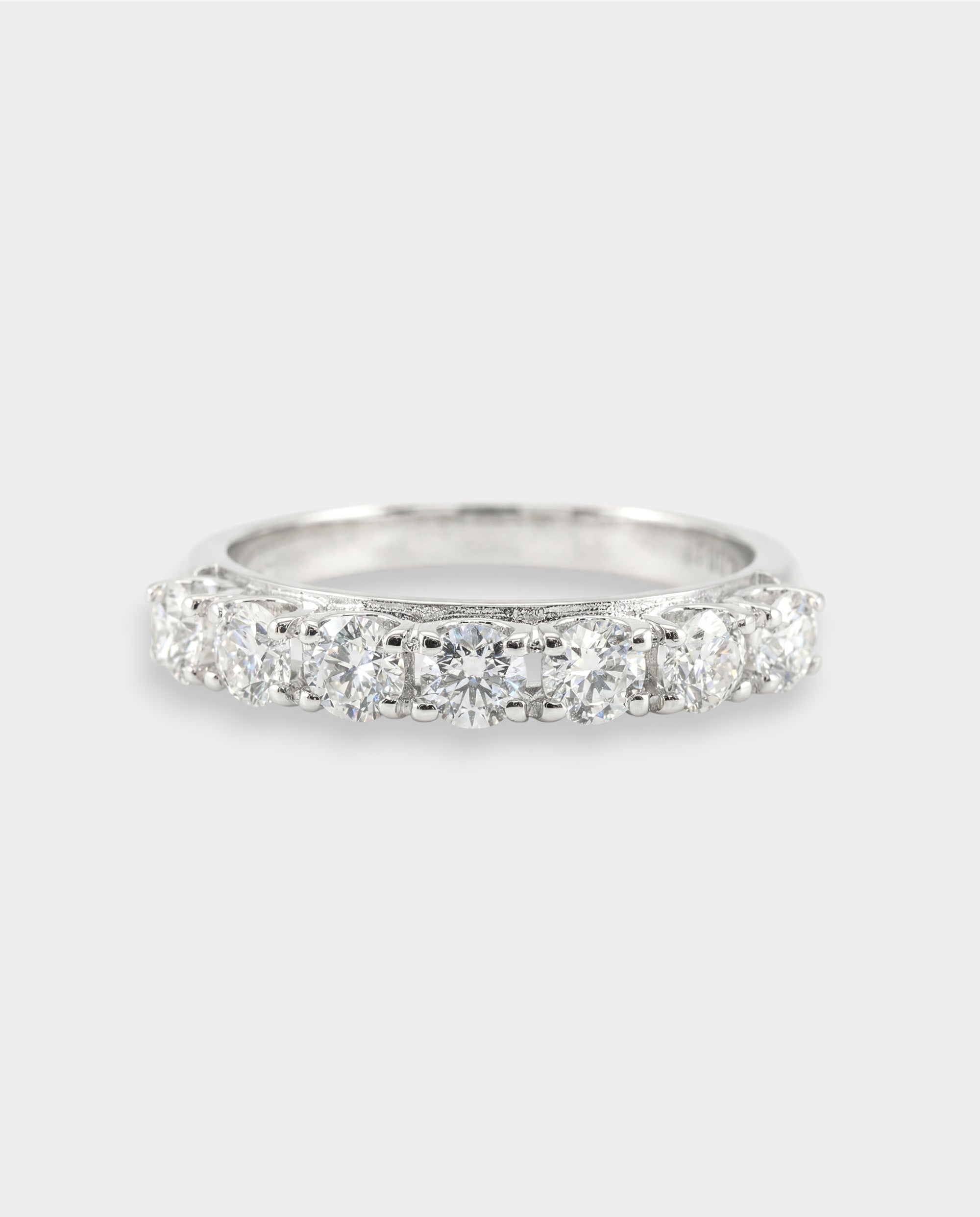 White gold ring with diamonds on a light gray background