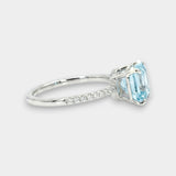 White gold ring with an aquamarine and diamond pave on a white background