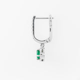 Silver hoop earring with a green emerald gemstone on a white background