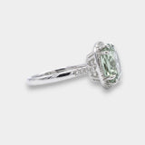 Green amethyst gemstone ring with diamond accents on a white background