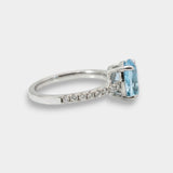 White gold ring with a blue topaz on a white background