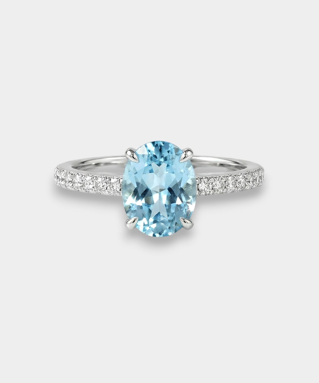 White gold ring with a blue topaz on a white background