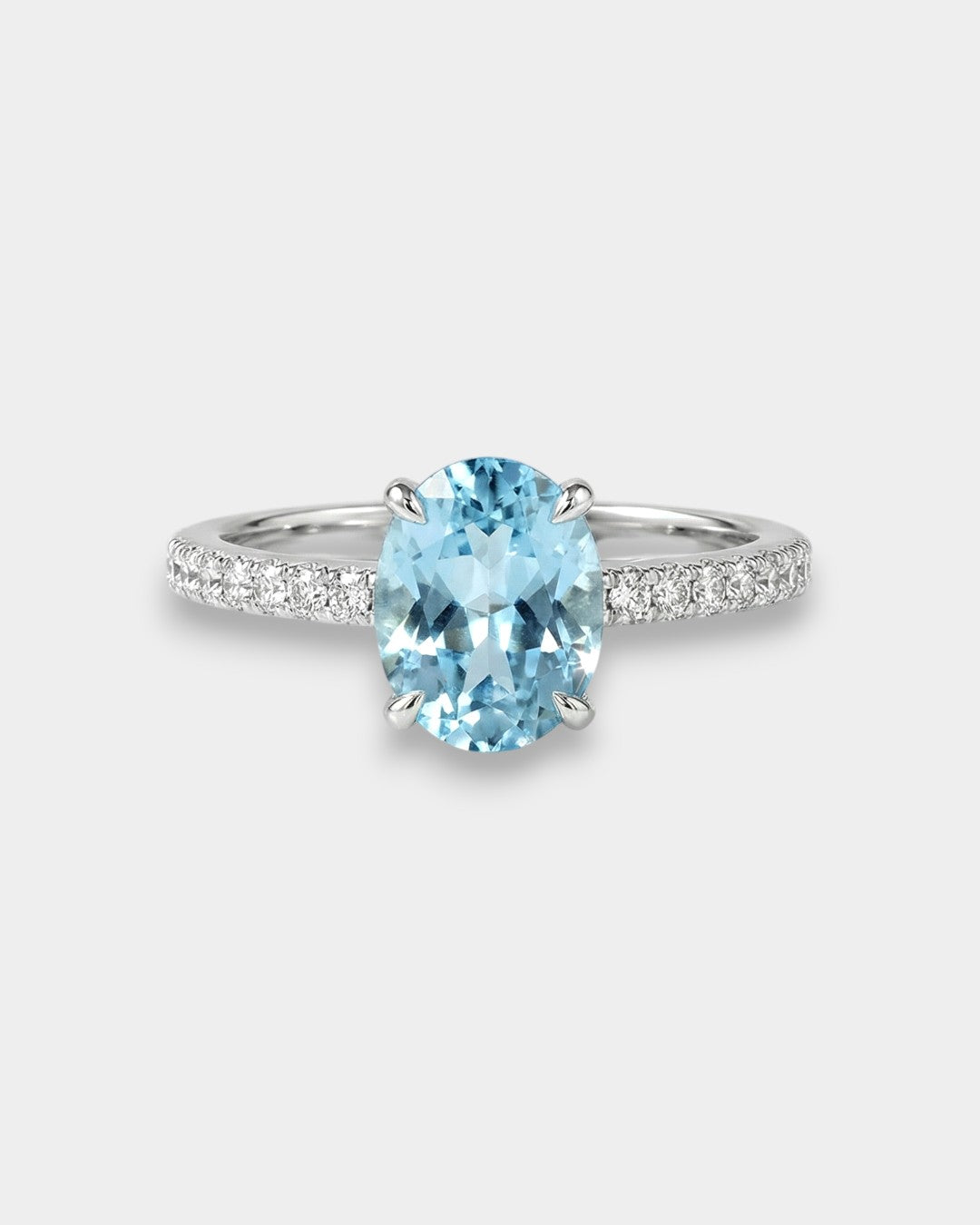 White gold ring with a blue topaz on a white background
