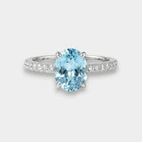 White gold ring with a blue topaz on a white background