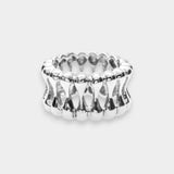 White gold ring with a textured design on a light gray background