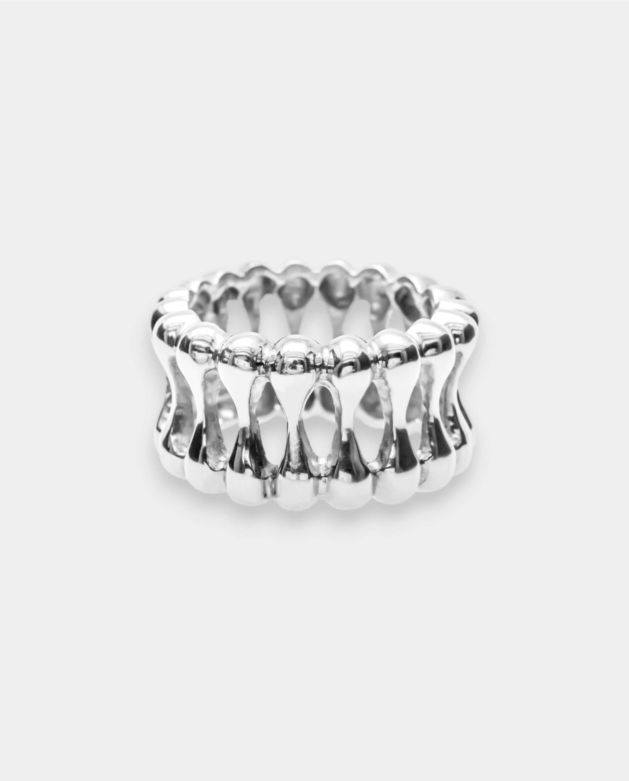 White gold ring with a textured design on a light gray background