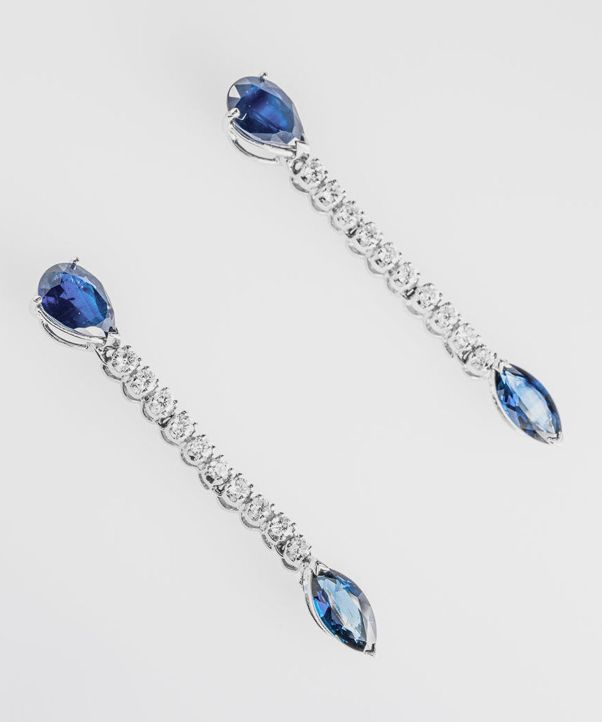 Pair of earrings with sapphires and clear diamonds on a white background