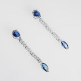 Pair of earrings with sapphires and clear diamonds on a white background