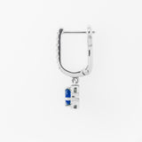 White gold hoop earring with a blue sapphire on a white background