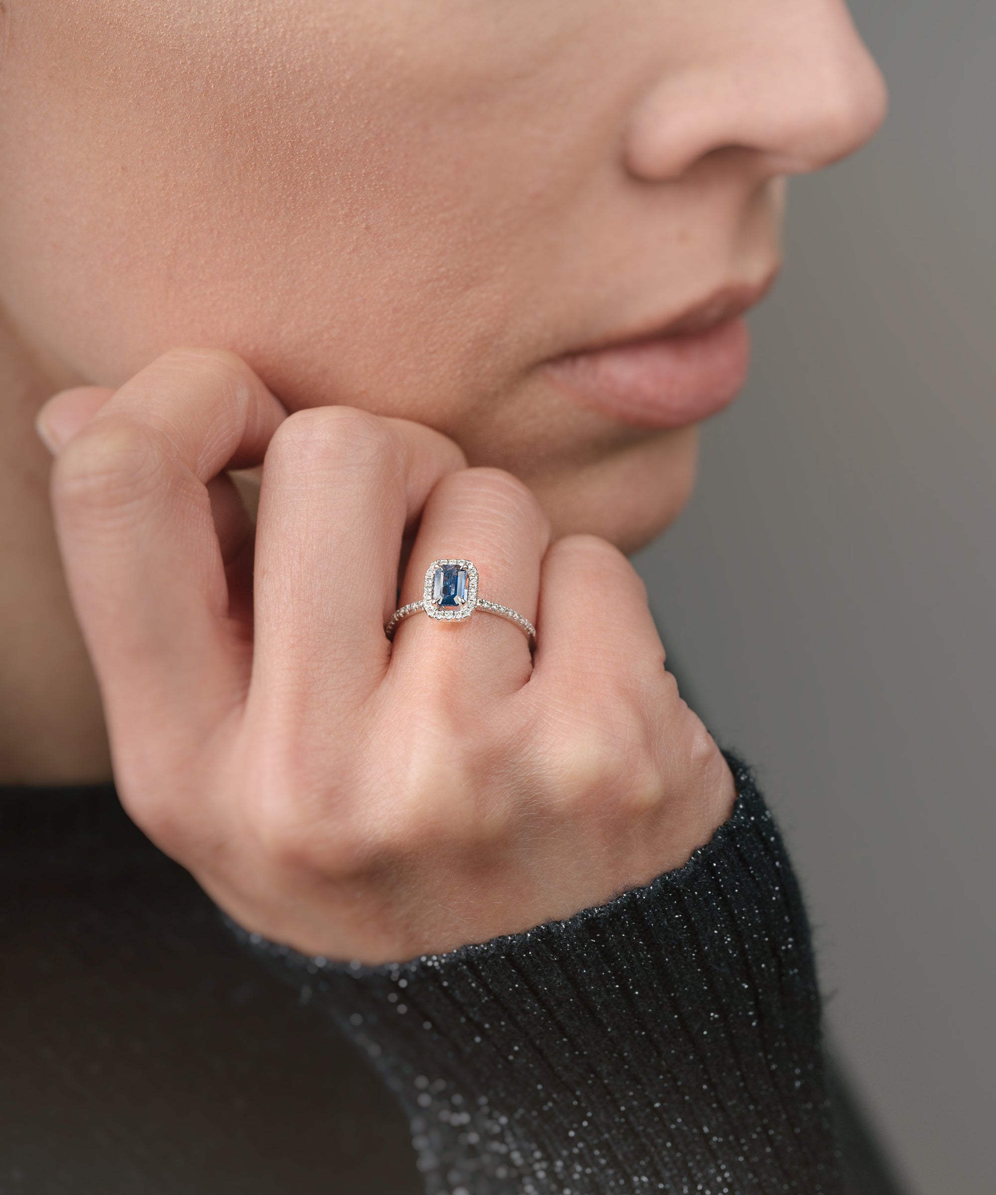 Ring with a sapphire and diamond accents on a white background