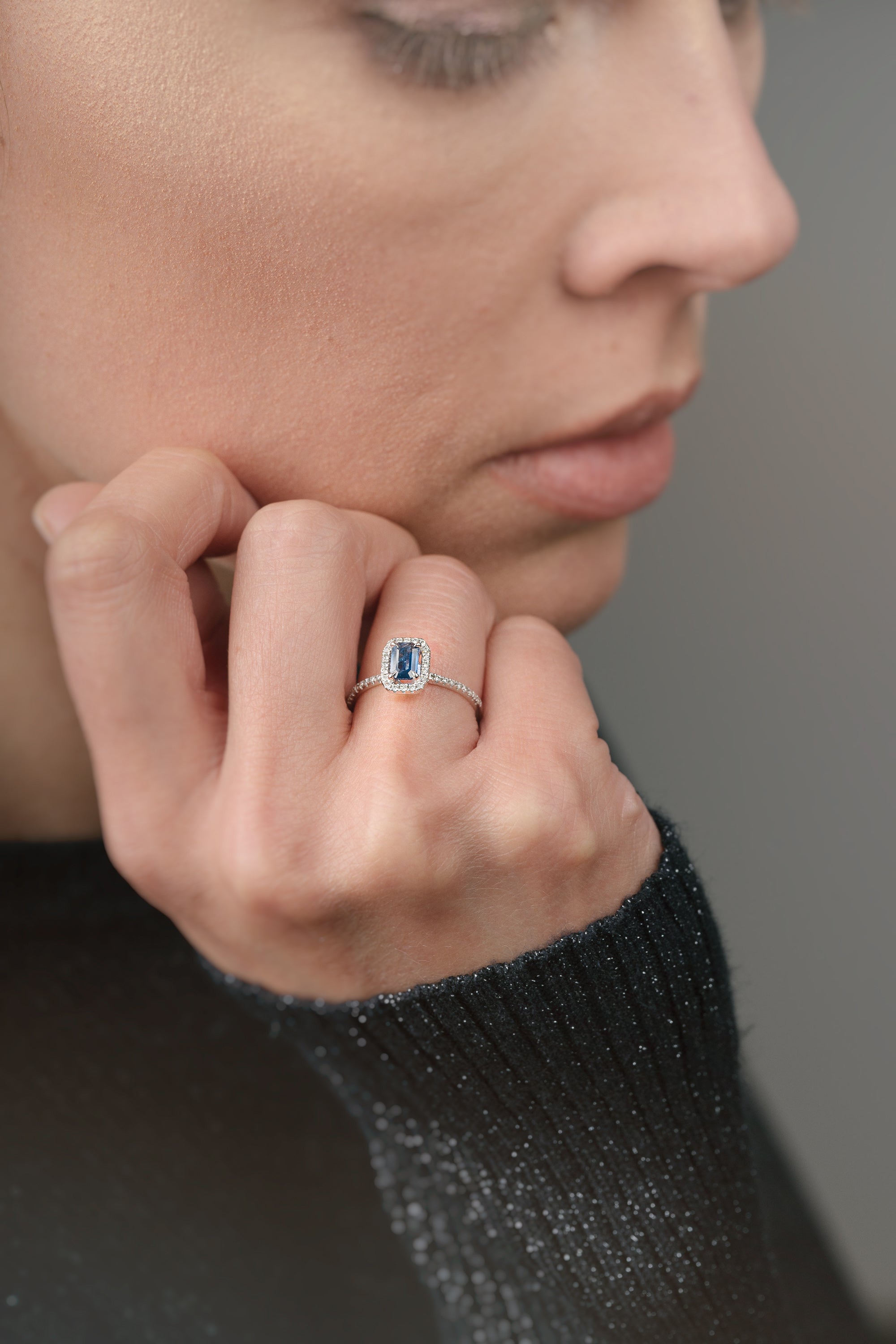 Ring with a sapphire and diamond accents on a white background