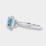 Ring with a topaz and diamond accents on a white background side view 