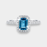 Ring with a topaz and diamond accents on a white background