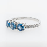 White gold ring with sapphires and small diamonds on a white background