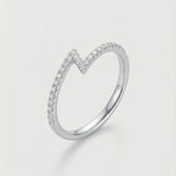 White gold z-shaped ring with small diamonds on a light gray background