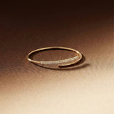 Gold bracelet with small stones on a gradient brown background