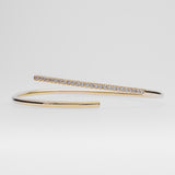 Gold bracelet with small diamonds on a light gray background