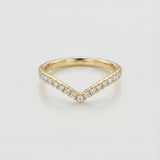 Gold chevron ring with diamond accents on a light gray background