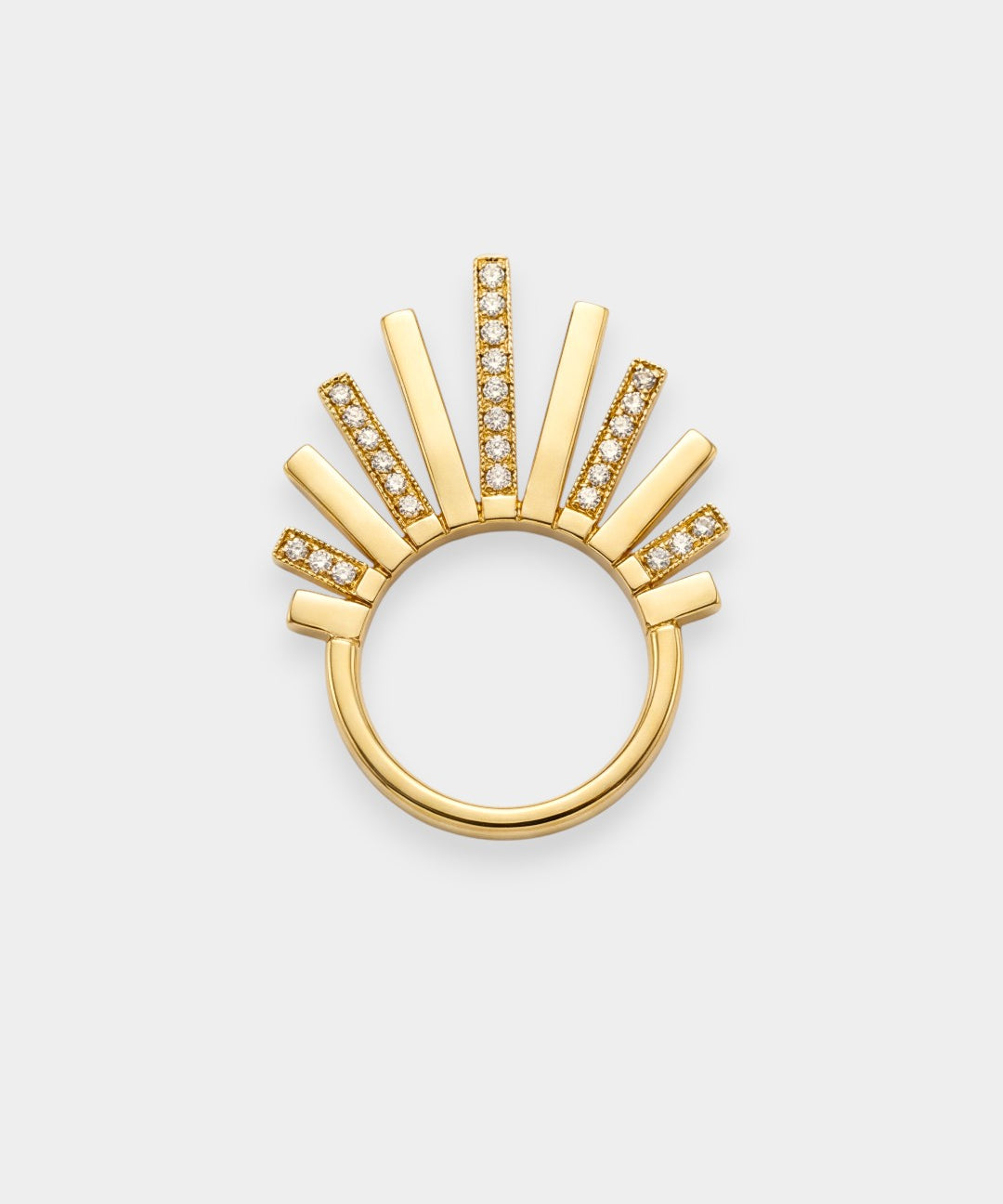 Gold ring with sunburst design on a white background