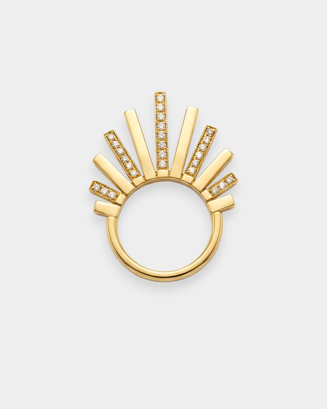 Gold ring with sunburst design on a white background