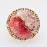 Jewelry with pink stone and diamond-studded gold border on a white background