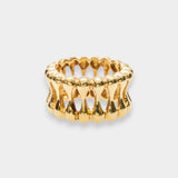 Gold ring with a textured design on a white background