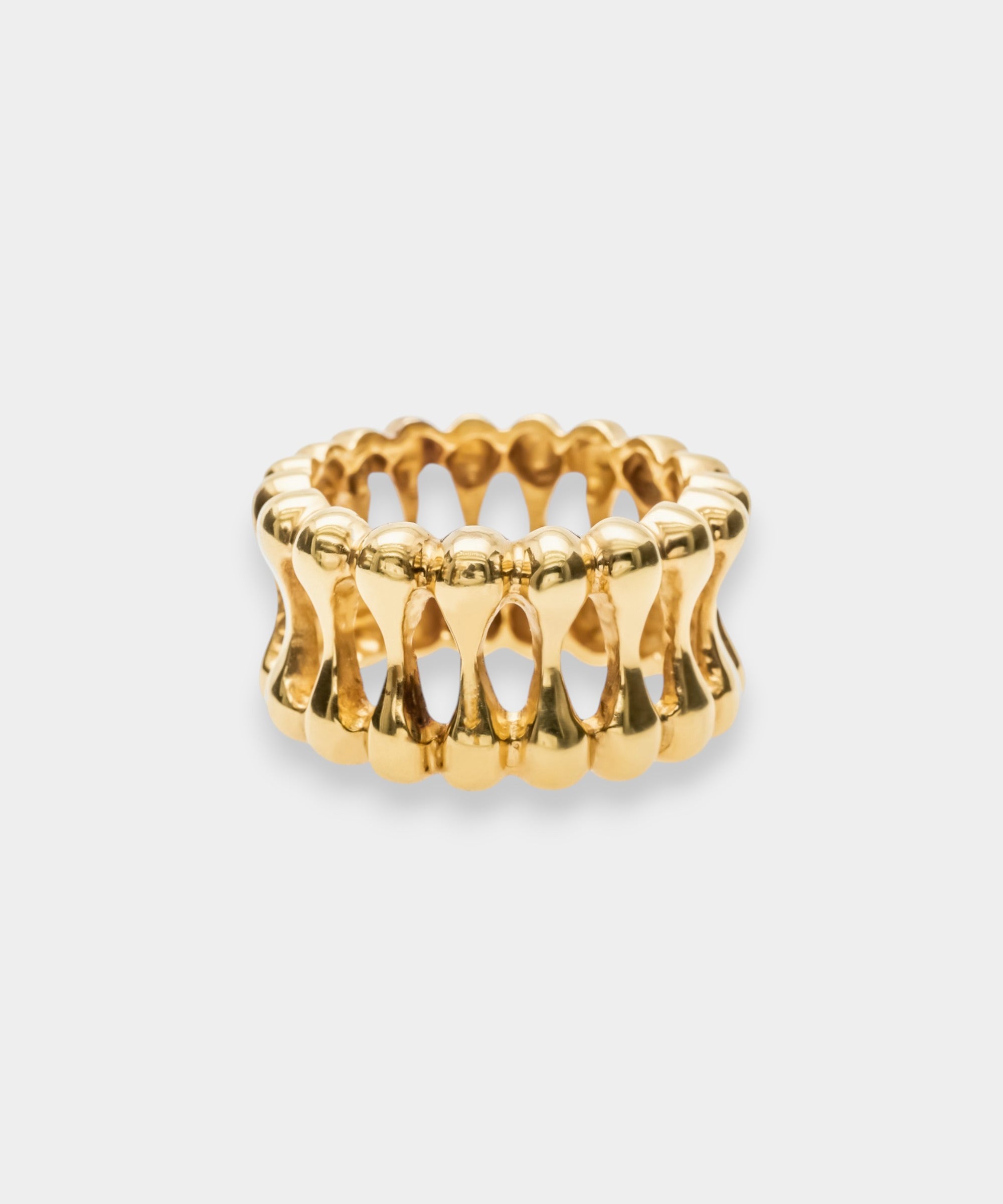 Gold ring with a textured design on a white background