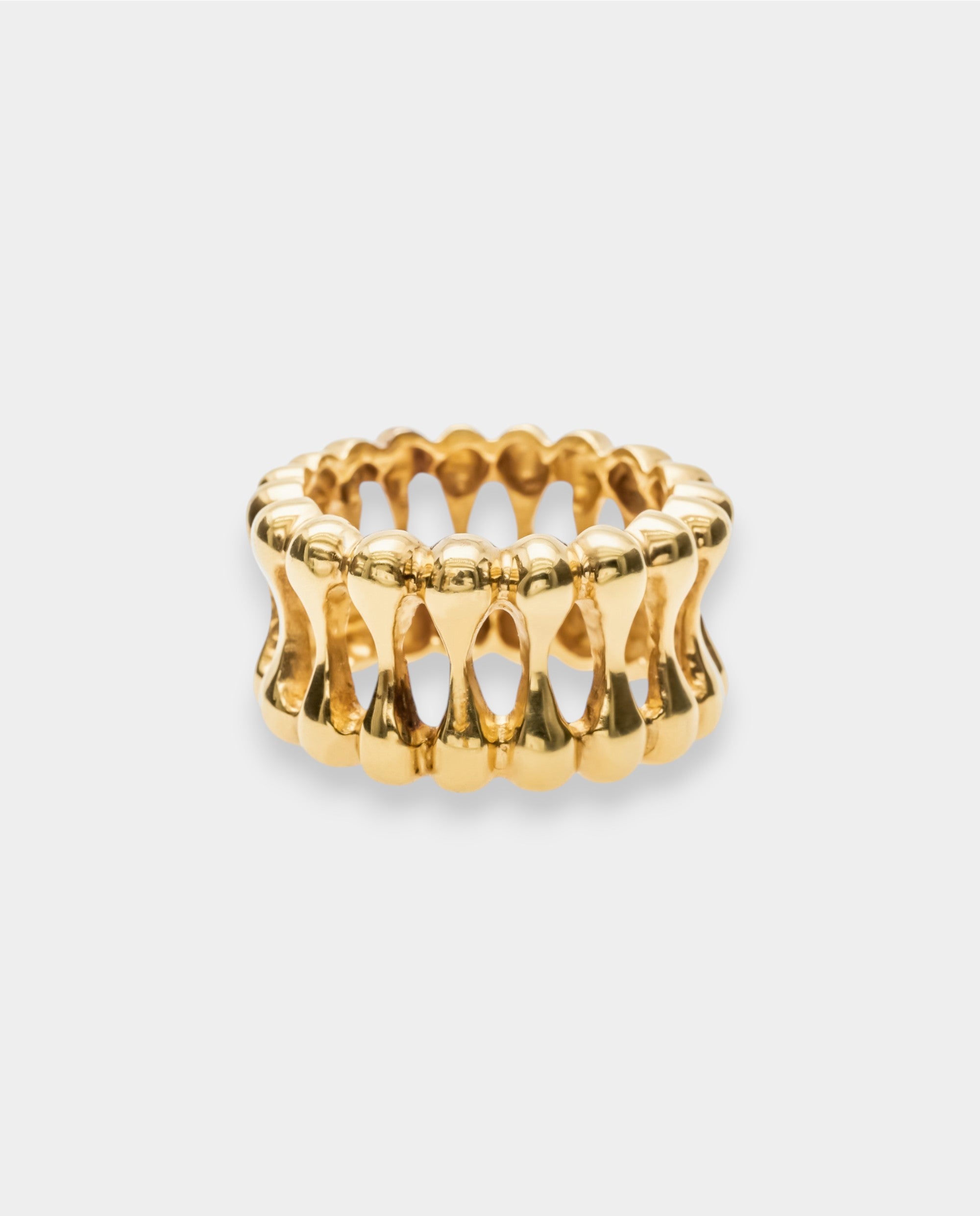 Gold ring with a textured design on a white background