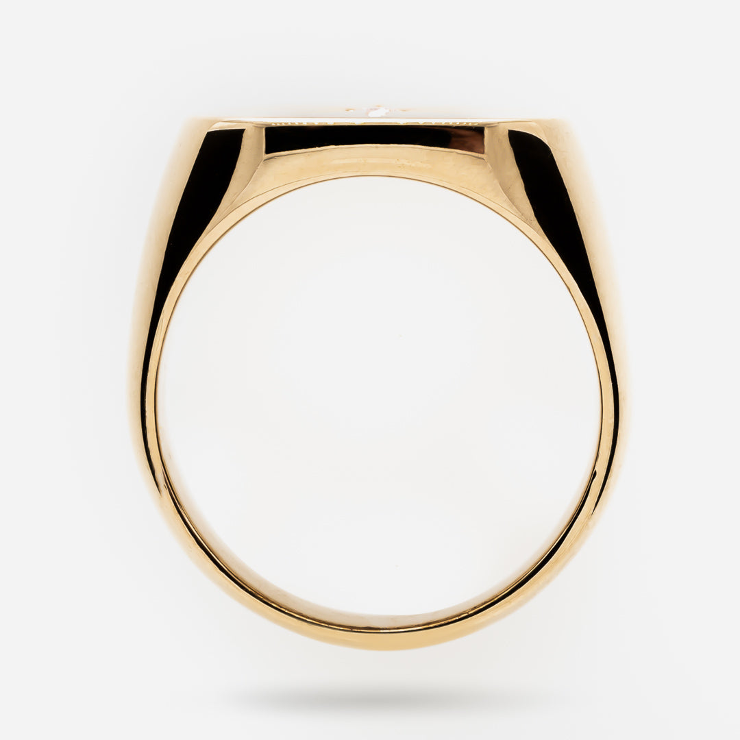 Gold signet ring on a white background